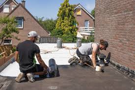 Professional roofing crew with branded company truck arriving at a residential job site at sunrise
